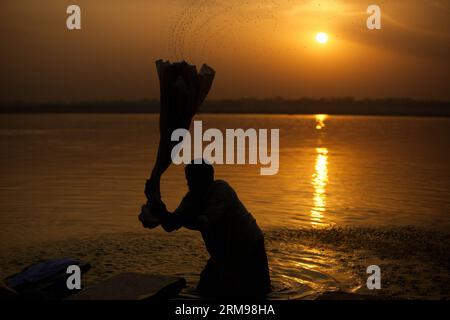 (140513) -- VARANASI, 13. Mai 2014 (Xinhua) -- Ein Mann wäscht Kleidung, während die Sonne über dem Ganges in Varanasi, Uttar Pradesh, Indien, 13. Mai 2014 aufgeht. (Xinhua/Zheng HUANSONG) INDIAN-VARANASI-GANGES-SCENE PUBLICATIONxNOTxINxCHN Varanasi 13. Mai 2014 XINHUA ein Mann wäscht Kleidung, während die Sonne über dem Ganges in Varanasi aufgeht Uttar Pradesh Indien 13. Mai 2014 XINHUA Zheng Huansong Indian Varanasi Ganges Scene PUNOBLICxINxCHN Stockfoto