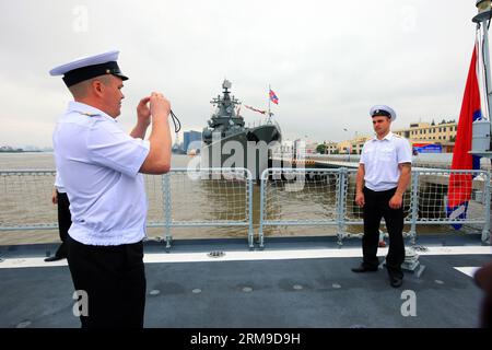 (140519) -- SHANGHAI, May 19, 2014 (Xinhua) -- Soldiers of Russian guided missile cruiser Varyag take pictures while visiting China s missile destroyer Zhengzhou in Shanghai, east China, May 19, 2014. Chinese and Russian naval forces held interchange activities on Monday to enhance mutual communication. The Joint Sea-2014 drill will be held in the northern part of the East China Sea between May 20 and 26. This will be the third such exercise after joint drills off the coast of Russia s Far East in July 2013 and the Yellow Sea in April 2012. (Xinhua/Zha Chunming) (zc) CHINA-SHANGHAI-JOINT NAVAL Stock Photo