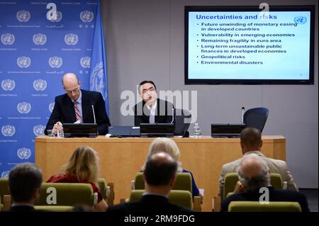 (140521) -- NEW YORK, May 21, 2014 (Xinhua) -- Hong Pingfan (R), chief of the Global Economic Monitoring Unit for the UN Department of Economic and Social Affairs (DESA), speaks during a press conference at the UN headquarters in New York, on May 21, 2014. The global economy is expected to strengthen over the next two years, despite a downgrade of growth prospects for some developing economies and economies in transition, a UN report said here Wednesday, adding that growth for emerging economies is revised slightly down. (Xinhua/Niu Xiaolei) UN-NEW YORK-WORLD ECONOMY-REPORT PUBLICATIONxNOTxINx Stock Photo