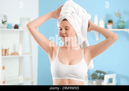 Teenage girl with acne problem in bathroom Stock Photo