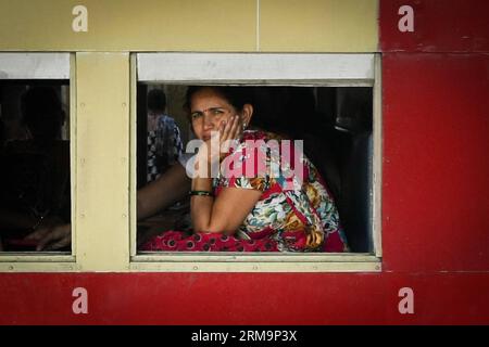 HIMACHAL PRADESH, May 28, 2013 (Xinhua) -- A passenger sits in a train heading for Shimla along the Kalka-Shimla Railway in Kalka, north India s Haryana, May 28, 2014. The Kalka-Shimla Railway is a 762?mm narrow gauge railway in North-West India s Himachal Pradesh travelling along a mostly mountainous route from Kalka to Shimla. It is known for dramatic views of the hills and surrounding villages. The 96-km long railway was built since 1898 to provide a service to the highland town of Shimla. Three still fully operational railways, the Darjeeling Himalayan Railway in India s West Bengal, the N Stock Photo