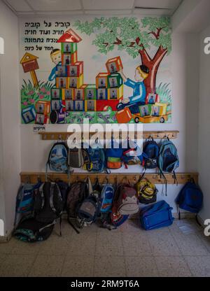 Orthodox Jewish pupils bags are seen outside a classroom of Torat Moshe elementary school in Beit Shemesh, about 20 km from Jerusalem, on May 29, 2014. Tzviel Noyman is an Israeli Ultra-Orthodox boy in a family with six children, three boys and three girls. He is ten years old this year and a grade three pupil of Torat Moshe elementary school, which is only opened to Jewish children. Tzviel has eight classes each day, including Hebrew, English, mathematics and Jewish religion, which has four classes each day including Talmud, Mishnah and Gemara. Tzviel likes the religion class best because he Stock Photo