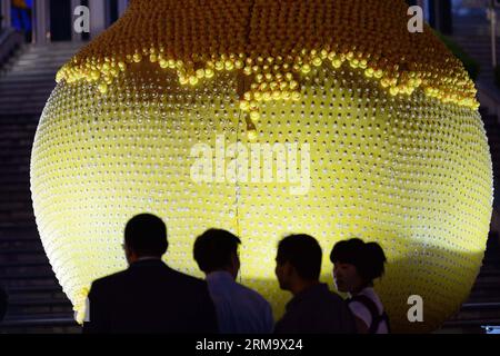 (140604) -- SHANGHAI, 4. Juni 2014 (Xinhua) -- Menschen beobachten eine Birnenskulptur, auf der die Gummienten von Besuchern in Shanghai, Ostchina, am 4. Juni 2014 abgeschält werden. Die Birnenskulptur, die aus mehr als 15.000 Gummienten bestand, zog eine große Menge von Besuchern an und viele haben die Gummienten von der Birne weggeschält, was laut Veranstalter einen Verlust von über 100.000 Yuan (16.100 US-Dollar) verursachte. Der Vorfall hat eine hitzige Online-Debatte ausgelöst, bei der viele Internetnutzer die Tat verurteilen. (Xinhua/Lai Xinlin) (lfj) CHINA-SHANGHAI-BIRNE SKULPTUR-GUMMI ENTENVERLUST (CN) PUBLICATIONxNOT Stockfoto