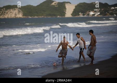 (140610) -- NATAL, June 10, 2014 (Xinhua) -- Youngsters play football at the Praia de Ponta Negra beach in Natal, Brazil on June 10, 2014. The 2014 FIFA World Cup will be held in Brazil from June 12 to July 13. (Xinhua/Mauricio Valenzuela) (rh) BRAZIL-NATAL-WORLD CUP 2014-DAILY LIFE PUBLICATIONxNOTxINxCHN   Natal June 10 2014 XINHUA Youngsters Play Football AT The Praia de Ponta Negra Beach in Natal Brazil ON June 10 2014 The 2014 FIFA World Cup will Be Hero in Brazil from June 12 to July 13 XINHUA Mauricio Valenzuela Rh Brazil Natal World Cup 2014 Daily Life PUBLICATIONxNOTxINxCHN Stock Photo