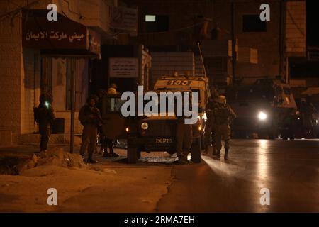 Israeli soldiers patrol during a military operation to search for three missing Israeli youths in the West Bank city of Beit Sahour near Bethlehem, June 22, 2014. The Israeli army shot dead early on Sunday two Palestinians in the West Bank, medical and security sources said. Palestinian security sources told Xinhua that large Israeli forces stormed a refugee camp and raided dozens of houses, searching for three missing Israelis who disappeared in June 12 in the West Bank. (Xinhua/Luay Sababa)(zhf) MIDEAST-BETHLEHEM-ISRAEL-MILITARY PUBLICATIONxNOTxINxCHN   Israeli Soldiers Patrol during a Milit Stock Photo