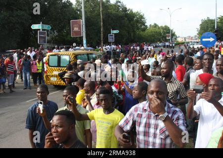 People gather around the site of a bomb explosion in the central business area in Nigeria s capital Abuja, on June 25, 2014. At least 19 people have been killed and 52 others injured in a bomb attack that rocked Wuse area of Abuja on Wednesday. (Xinhua/Olatunji Obasa) NIGERIA-ABUJA-EXPLOSION-CASUALTY PUBLICATIONxNOTxINxCHN   Celebrities gather Around The Site of a Bomb Explosion in The Central Business Area in Nigeria S Capital Abuja ON June 25 2014 AT least 19 Celebrities have been KILLED and 52 Others Injured in a Bomb Attack Thatcher Rocked Wuse Area of Abuja ON Wednesday XINHUA Olatunji Ob Stock Photo