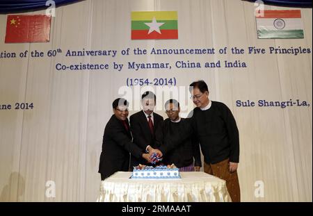 (140628) -- YANGON, June 28, 2014 (xinhua) -- Sailas Thangal (1st L), Charge d Affaires of the Indian Embassy, Chen Chen (2nd L), Charge d Affaires of the Chinese Embassy, Yangon Region Chief Minister U Myint Swe (2nd R) and U Thant Kyaw, Deputy Minister for Foreign Affairs, cut the cake during the commemoration ceremony of the 60th Anniversary of the Announcement of the Five Principles of Peaceful Coexistence in Yangon, Myanmar, June 28, 2014. The Myanmar Foreign Ministry organized a function to commemorate the 60th anniversary of the Five Principles of Peaceful Coexistence, which falls on Sa Stock Photo