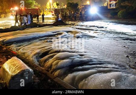 (140701) -- DALIAN, July 1, 2014 (Xinhua) -- Foams used to dilute crude oil spread all over the road after a crude oil spill from a pipeline of PetroChina, the country s largest oil and gas producer, caused a huge fire in Dalian, a coastal city in northeast China s Liaoning Province, July 1, 2014. The oil pipeline near Dalian University in Jinzhou New District was damaged and oil leaked due to the drilling operation of a local construction engineering company on Monday evening. The spill flew into the urban sewage pipeline network and fire broke out at the exit of the urban pipelines. Resident Stock Photo