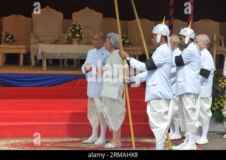 (140711) -- PHNOM PENH, July 11, 2014 (Xinhua) -- Queen Mother Norodom Monineath (2nd L), wife of Cambodia s late King Father Norodom Sihanouk, and her son, current King Norodom Sihamoni (1st L), attend the parade in Phnom Penh, Cambodia, July 11, 2014. Thousands of people attended a religious procession on Friday morning to enshrine the remains of Cambodia s most revered King Father Norodom Sihanouk, who died of illness in Beijing in 2012. (Xinhua/Li Hong) CAMBODIA-PHNOM PENH-SIHANOUK-PARADE PUBLICATIONxNOTxINxCHN   Phnom Penh July 11 2014 XINHUA Queen Mother Norodom Monineath 2nd l wife of C Stock Photo