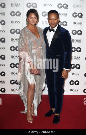 Chrissy Teigen and John Legend attend the GQ Men of the Year Awards at Tate Modern  in London. Stock Photo