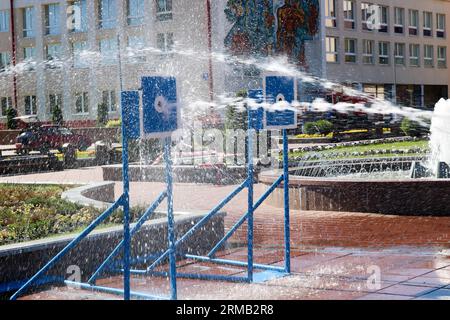 Ein nasser, kraftvoller Wasserstrahl spritzt und schießt auf das Ziel, mit viel Druck auf die Straße bei der Attraktion, Wettbewerben. Stockfoto