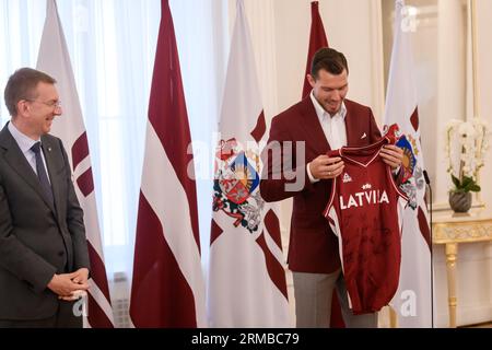 RIGA, Latvia. 14th Aug, 2023. Dairis Bertans (R) gives a gift for Edgars Rinkevics (L), President of Latvia, during meeting with National Men's basketball team of Latvia before FIBA BASKETBALL WORLD CUP 2023. Credit: Gints Ivuskans/Alamy Live News Stock Photo