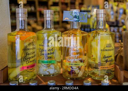 Menton, Frankreich - 26. Mai 2023: Bunte Ananas-, Ingwer-, Orangen-Vanille-Rum-Cocktails mit Früchten in Flaschen in einem Kunsthandwerksladen in der Altstadt Stockfoto
