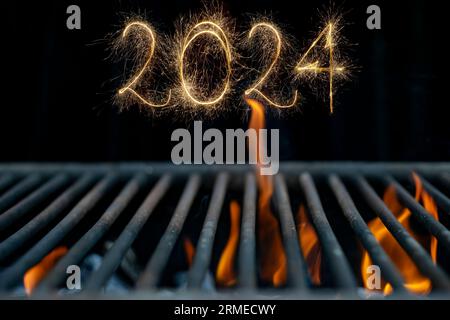 2024 geschrieben mit Glitzern auf leerem, heißem Grill mit orangen Flammen, Neujahrskulisse, selektiver Fokus Stockfoto