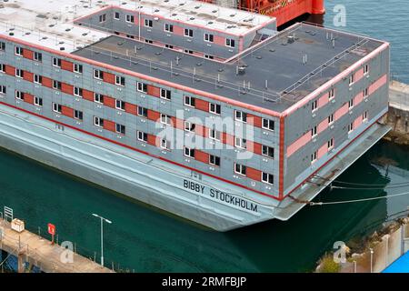 Portland, Dorset, Großbritannien. 28. August 2023. Allgemeine Sicht aus der Luft des leeren Bibby Stockholm Asylbewerberschiffs am Portland Port bei Weymouth in Dorset, der wegen der tödlichen Legionellenbakterien im Wasser evakuiert wurde. Es wird berichtet, dass die Migranten nicht vor Anfang September wieder in den Binnenschiffer einsteigen werden, da sie daran arbeiten, die Legionellenbakterien zu entfernen und zu testen, um festzustellen, ob sie ausgerottet sind. Die Feuerwehrgewerkschaft droht auch rechtliche Schritte, weil sie befürchtet, dass das Schiff unsicher ist. Bildnachweis: Graham Hunt/Alamy Live News Stockfoto