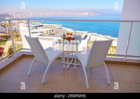 Köstliches Frühstück mit Omelette, Gebäck, Kaffee und Minztee auf dem Balkon mit Meerblick im marokkanischen Hotel Stockfoto