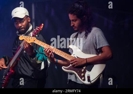 Simon Martinez spielt Gitarre mit Salami Rose Joe Louis beim Green man Festival in Wales, Großbritannien, August 2023. Foto: Rob Watkins Stockfoto