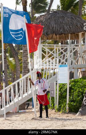 Bavaro, Dominikanische Republik - 12. Februar 2022: Rettungsschwimmer hisst am Bavaro Beach eine rote Flagge Stockfoto