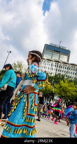 Edmonton, Alberta, Kanada. August 2023. Ein junger Teilnehmer, der ein traditionelles Jingle-Kleid trägt, nimmt an der Veranstaltung Teil. Als das Pride Weekend in Edmonton beginnt, erkennt die indigene Gemeinschaft das Ereignis mit dem 2 Spirit Powwow an. Der Begriff Two-Spirit ist eine direkte Übersetzung des Ojibwe-Begriffs Niizh manidoowag. „Zweigeist“ oder „Zweigeist“ wird normalerweise verwendet, um eine Person anzuzeigen, deren Körper gleichzeitig einen männlichen und einen weiblichen Geist beherbergt. Ein Teil der Feier ist die Inklusivität aller und die Begrüßung aller zum Feiern, indem sie in einem Jig-Tanz konkurrieren. Alle bei Stockfoto