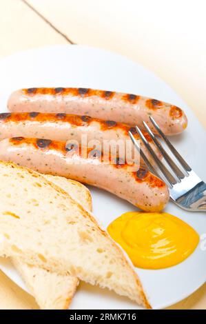 Traditionelle, frische deutsche Wurstwurst, gegrillt mit gelbem Senf Stockfoto