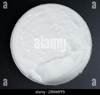 Offene Box mit weißem Creme über der Draufsicht isoliert auf Studiohintergrund Stockfoto