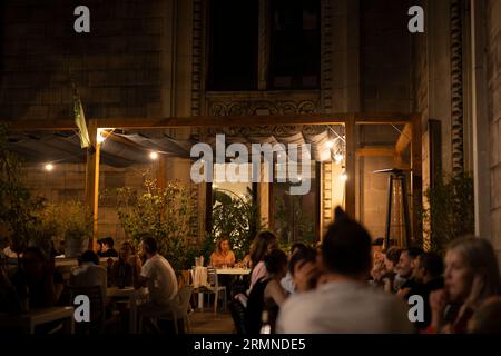 Am 25. August 2023 werden Menschen in einem Café-Restaurant in Warschau, Polen, bei einem warmen Sommerabend beobachtet. Stockfoto