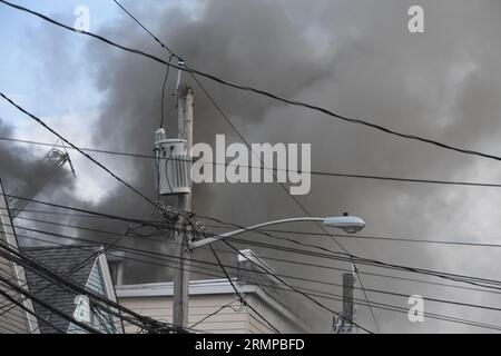 Newark, New Jersey, USA. 29. August 2023. (NEU) zwei-Alarm-Feuer in Newark, New Jersey. 29. August 2023, Newark, New Jersey, USA: Feuerwehrleute kämpften gegen Flammen, die in einem Mehrfamilienhaus durch einen Brand in Newark, New Jersey, ausbrachen. Das zwei-Alarm-Feuer brach in einem dreistöckigen Wohnhaus an der 634 15th Avenue gegen 17:00 Uhr am Dienstag (29) Nachmittag aus. Es wurden keine Verletzungen gemeldet. (Bild: © Kyle Mazza/TheNEWS2 über ZUMA Press Wire) NUR REDAKTIONELLE VERWENDUNG! Nicht für kommerzielle ZWECKE! Stockfoto