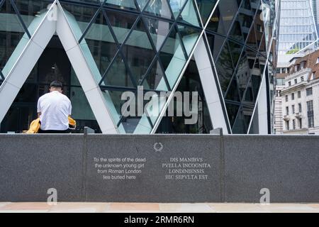 Ein einsamer Mann sitzt unter dem Gherkin-Gebäude – den Geistern der Toten liegt hier das unbekannte junge Mädchen aus römischem London beigesetzt Stockfoto