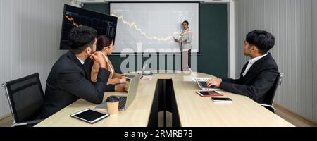 Strategisierung in Synergie. Verschiedene Experten, die an einer gemeinsamen Sitzung teilnehmen und an einem unübersichtlichen Konferenztisch Brainstorming betreiben. Stockfoto