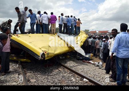 (140725) -- HYDERABAD, 25. Juli 2014 (Xinhua) -- Menschen versammeln sich am Ort des Verkehrsunfalls in Masayapeta bei Hyderabad, Hauptstadt des südindischen Bundesstaates Telangana, 24. Juli 2014. Mindestens 20 Schüler und ihr Schulbusfahrer wurden getötet, während 20 andere Schüler verletzt wurden, nachdem ein schneller Zug am Donnerstag an einem unbemannten Übergang in den Bus gerammt war, sagte ein Polizeibeamter. (Xinhua/Stringer) INDIEN-HYDERABAD-VERKEHRSUNFALL PUBLICATIONxNOTxINxCHN HYDERABAD Juli 25 2014 XINHUA-Prominente versammeln sich AM Ort des Verkehrsunfalls IN DER Nähe von Hyderabad Hauptstadt des südindischen Bundesstaates Telangana Stockfoto