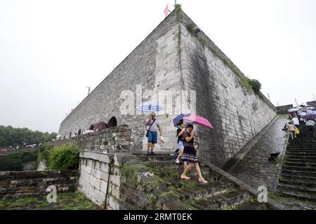 Touristen besuchen das Zhonghuamen-Tor, eine Barbakane, die Teil der alten Stadtmauer von Nanjing ist, der Hauptstadt der ostchinesischen Provinz Jiangsu, 8. August 2014. Die Stadtmauer von Nanjing wurde zwischen 1366 und 1386, den frühen Jahren der Ming-Dynastie (1368–1644), errichtet. Nanjing war einst die Hauptstadt der Dynastie und wurde von vier Schichten aus Ziegelsteinmauern umschlossen. Nach sechs Jahrhunderten natürlicher Erosion und absichtlicher Zerstörung durch Menschen beträgt die Länge der verbliebenen Stadtmauer heute 25 Kilometer, was noch heute einen Weltrekord darstellt. () (LMM) CHINA-JIANGSU-NANJING-CITY WALL-TOURISM (CN) XINHUA PUBLIC Stockfoto