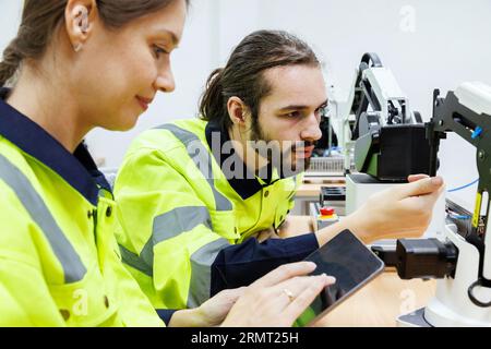 Studenten von Automatisierungstechnikern studieren Robotertrainingskits und untersuchen diese in der Robotik-Akademie an einer Universität oder Werkstätte. KI Stockfoto