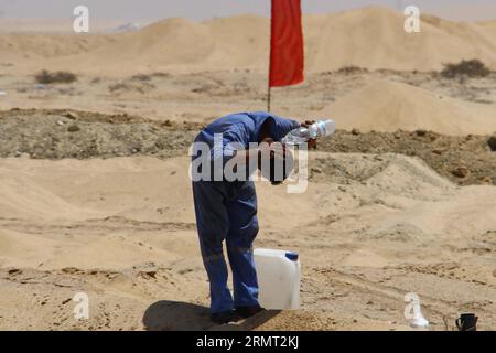 (140811) -- ISMAILIA, 10. August 2014 -- ein ägyptischer Arbeiter macht am 10. August 2014 eine Pause in der Nähe des Projekts des neuen Suez-Kanals in der Hafenstadt Ismailia, nordöstlich von Kairo, Ägypten. Der ägyptische Präsident Abdel Fattah al-Sisi stellte am vergangenen Dienstag den Bau eines 72 km langen neuen Suez-Kanals vor, der den Verkehr entlang der bestehenden Wasserstraße, die das Rote Meer mit dem Mittelmeer verbindet, beschleunigen und die geschwächte Wirtschaft Ägyptens ankurbeln soll. ) ÄGYPTEN-KAIRO-ISMAILIA-NEW SUZE CANAL AhmedxGomaa PUBLICATIONxNOTxINxCHN Ismailia Aug 10 2014 to Egyptian Worker macht eine Pause in der Nähe des Projekts New Suez Canal in Isma Stockfoto