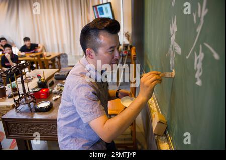 (140908) -- PEKING, 8. September 2014 -- Kunstlehrer Wu Di gibt die erste Klasse dieses Semesters an seine Studenten an der Experimental High School der Beijing Nomral University in Peking, Hauptstadt Chinas, 3. September 2014. Wu Di ist gelernter Kunstlehrer und arbeitet an der Experimental High School der Beijing Normal University. Währenddessen ist Wu, der in einer Vielzahl traditioneller chinesischer Künste versiert ist, als Meister der Malklasse Cheng Guan Tang und ein Superstar des Storytelling-Hauses Cheng Shu Guan bekannt. Wu studierte traditionelle chinesische Malerei an der Universität und hat ein d Stockfoto