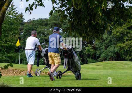 PRODUKTION - 24. August 2023, Niedersachsen, Adendorf: Golfer laufen über einen Golfplatz. Das Image der Golfer und ihrer Vereine ist voller Vorurteile: Zu elitär und nicht sehr umweltfreundlich. Ist die Bewässerung der langen Gänge in Zeiten von Wasserknappheit immer noch gerechtfertigt? (Zu dpa "zu wenig Regen: Golfplätze basteln an Bewässerungskonzepten") Foto: Philipp Schulze/dpa Stockfoto