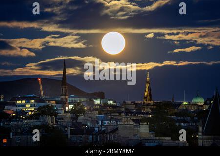 Der superblaue Mond erhebt sich über Edinburgh. Der blaue Mond bezieht sich auf den zweiten Vollmond in einem Kalendermonat, der etwa alle zwei oder drei Jahre stattfindet. Dieser ist auch Supermond, wenn der natürliche Satellit der Erde etwa 14 % größer und 30 % heller am Himmel erscheint, wenn er seinen nächsten Punkt zur Erde erreicht. Bilddatum: Mittwoch, 30. August 2023. Stockfoto