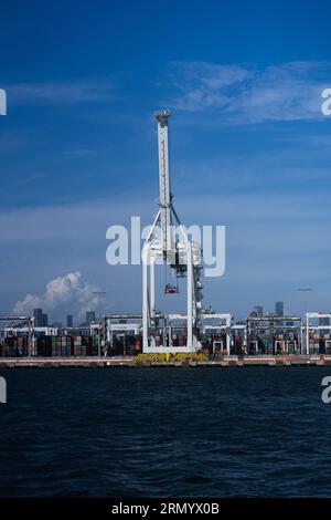 Bilder aus dem Hafen von Meblurne an einem schönen sonnigen Tag fokussierten sich auf einen großen Containerkran am Internierungscontainer-Terminal. Stockfoto