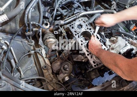 Mechaniker, der an einem Motor in einer Garage arbeitet Stockfoto