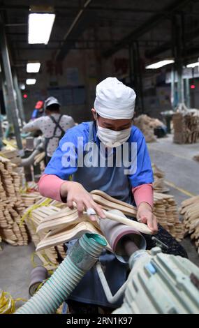 WIRTSCHAFT China - Bügel-Produktion in Lipu (150107) -- LIPU (GUANGXI), 6. Januar 2015 -- Arbeiter verarbeiten Kleiderbügel in einer Fabrik im Kreis Lipu, südwestchinesische autonome Region Guangxi Zhuang, 6. Januar 2015. Mit 126 Fabriken, die Kleiderbügel herstellen, erreichte die jährliche Produktion des Handels in Lipu 6,5 Milliarden RMB Yuan (etwa 1,06 Milliarden US-Dollar). (wf) CHINA-GUANGXI-CLOTHES HANGER-INDUSTRY(CN) LuxBo an PUBLICATIONxNOTxINxCHN Economy China Bügelproduktion in Lipu Lipu Guangxi 6. Januar 2015 Arbeiter verarbeiten Kleiderbügel IN einer Fabrik in Lipu County Südwestchina S Guang Stockfoto