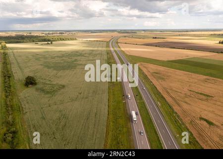 Drohnenfotografie von Autobahnen, die von landwirtschaftlichen Feldern umgeben sind, während des Sommers Stockfoto