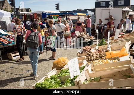 Kunden wandern auf dem Wochenmarkt in Plougasnou, Britanny, Frankreich. Stockfoto