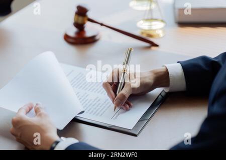 Anwälte oder Richter unterzeichnen Dokumente in Übereinstimmung mit rechtlichen und fairen Vertragsbedingungen Stockfoto