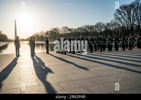 US Marine Corps Silent Drill Platoon Lincoln Memorial Washington DC | WASHINGTON D.C., Vereinigte Staaten — Marines des U.S. Marine Corps Silent Drill Platoon üben im Morgengrauen am Spiegelbecken des Lincoln Memorials, ihre langen Schatten erstrecken sich über die Plaza in Richtung des Washington Monument. Die Elite-Einheit mit 24 Mitgliedern trainiert ohne verbale Kommandos, und diese frühe Übungssession zeigt die Disziplin hinter ihren bekannteren abendlichen Zeremonienauftritten. Stockfoto