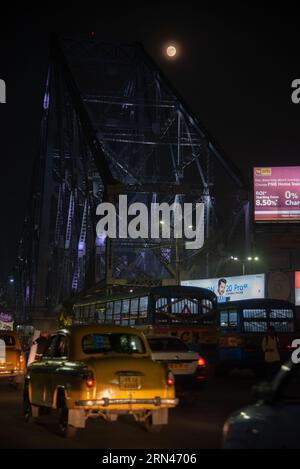 Kalkutta, Indien. 30. August 2023. Der blaue Supermond, der zweite Supermond im August, erhebt sich am Himmel neben der Howrah-Brücke in Kalkutta. (Foto: Dipa Chakraborty/Pacific Press) Credit: Pacific Press Media Production Corp./Alamy Live News Stockfoto