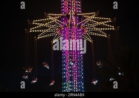 ORLANDO, Florida, USA – der Orlando StarFlyer erleuchtet den Nachthimmel im Icon Park in Orlando, Florida. Mit einer Höhe von 450 Metern ist der StarFlyer die höchste Schaukel der Welt. Die Attraktion bietet den Besuchern einen Panoramablick auf die Stadt und die Unterhaltungsviertel von Orlando. Stockfoto