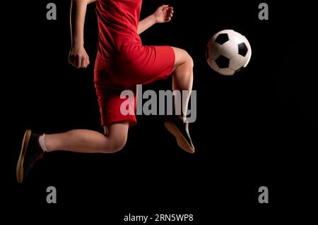 Nahaufnahme Frau tritt Ball mit Knie Stockfoto