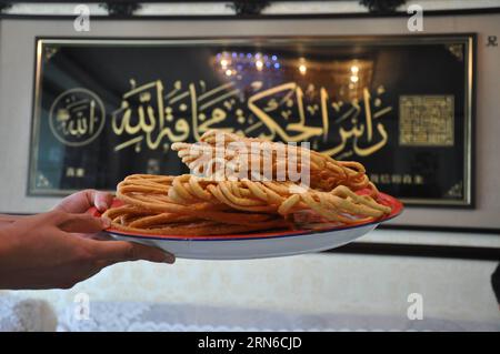 Eine muslimische Familie im Dorf Najiahu stellt traditionelle frittierte Snacks aus Öl her und feiert das Eid al-Fitr-Festival, das das Ende des islamischen heiligen Monats Ramadan in Yongning County von Yinchuan, der Hauptstadt der nordwestchinesischen Autonomen Region Ningxia Hui, am 17. Juli 2015 markiert. Das Dorf Najiahu ist ein Dorf mit 5.200 Einwohnern, von denen über 98 Prozent Hui-Muslime sind. (hgh) CHINA-NINGXIA-YINCHUAN-EID AL-FITR SPECIAL SNACKS (CN) JinxZhengfei PUBLICATIONxNOTxINxCHN eine muslimische Familie im Dorf Najiahu stellt traditionelle ölgebratene Snacks her, um das Oath Al Fitr Festival zu feiern, das Marks Th Stockfoto