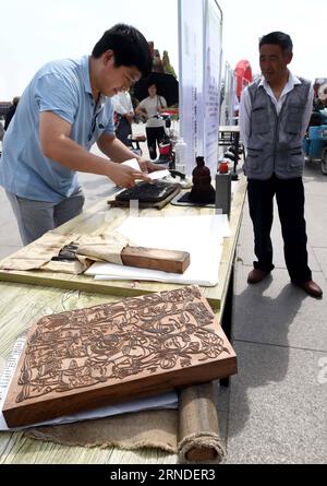 (160518) -- KAIFENG, 18. Mai 2016 -- Ein Mitarbeiter des Kaifeng New Year Paintings Museum fertigt traditionelle Holzschnitte für das neue Jahr an, während einer Veranstaltung zum Internationalen Museumstag in Kaifeng, Provinz Henan in Zentralchina, 18. Mai 2016. ) (wx) CHINA-KAIFENG-INTERNATIONAL MUSEUM DAY(CN) LixAn PUBLICATIONxNOTxINxCHN 160518 Kaifeng 18. Mai 2016 ein Mitarbeiter des Kaifeng New Year Paintings Museum fertigt traditionelle Holzschnitte Silvester Gemälde während der Veranstaltung anlässlich des Internationalen Museumstages in Kaifeng Central China S Henan Province 18. Mai 2016 wx China Kaifeng Internatio Stockfoto