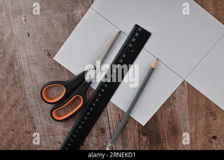 Hände einer älteren Frau falten Origami-Papier. Erstellen eines Origami-Papierkrans, Nahaufnahme Stockfoto