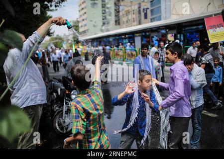 (160701) -- TEHERAN, 1. Juli 2016 -- iranische Kinder kühlen sich während des Al-Quds-Tages am 1. Juli 2016 bei einer Kundgebung im iranischen Zentrum von Teheran ab. Der letzte Freitag des islamischen heiligen Monats Ramadan wird in vielen muslimischen Ländern als Al-Quds-Tag begangen, um die Unterstützung der Palästinenser zum Ausdruck zu bringen und die Bedeutung Jerusalems für die Muslime hervorzuheben. Al-Quds ist der arabische Name für Jerusalem. IRAN-TEHERAN-RALLY-QUDS TAG AhmadxHalabisaz PUBLICATIONxNOTxINxCHN 160701 TEHERAN 1. Juli 2016 iranische Kinder kühlen sich bei einer RALLYE in der Innenstadt von TEHERAN Iran während des Al Quds Tag AM 1. Juli 2016 The Load Fr ab Stockfoto